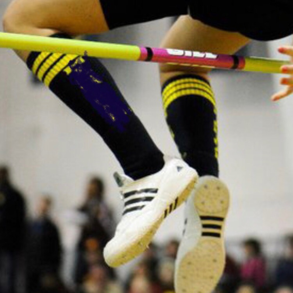White and black adidas high jump spikes
